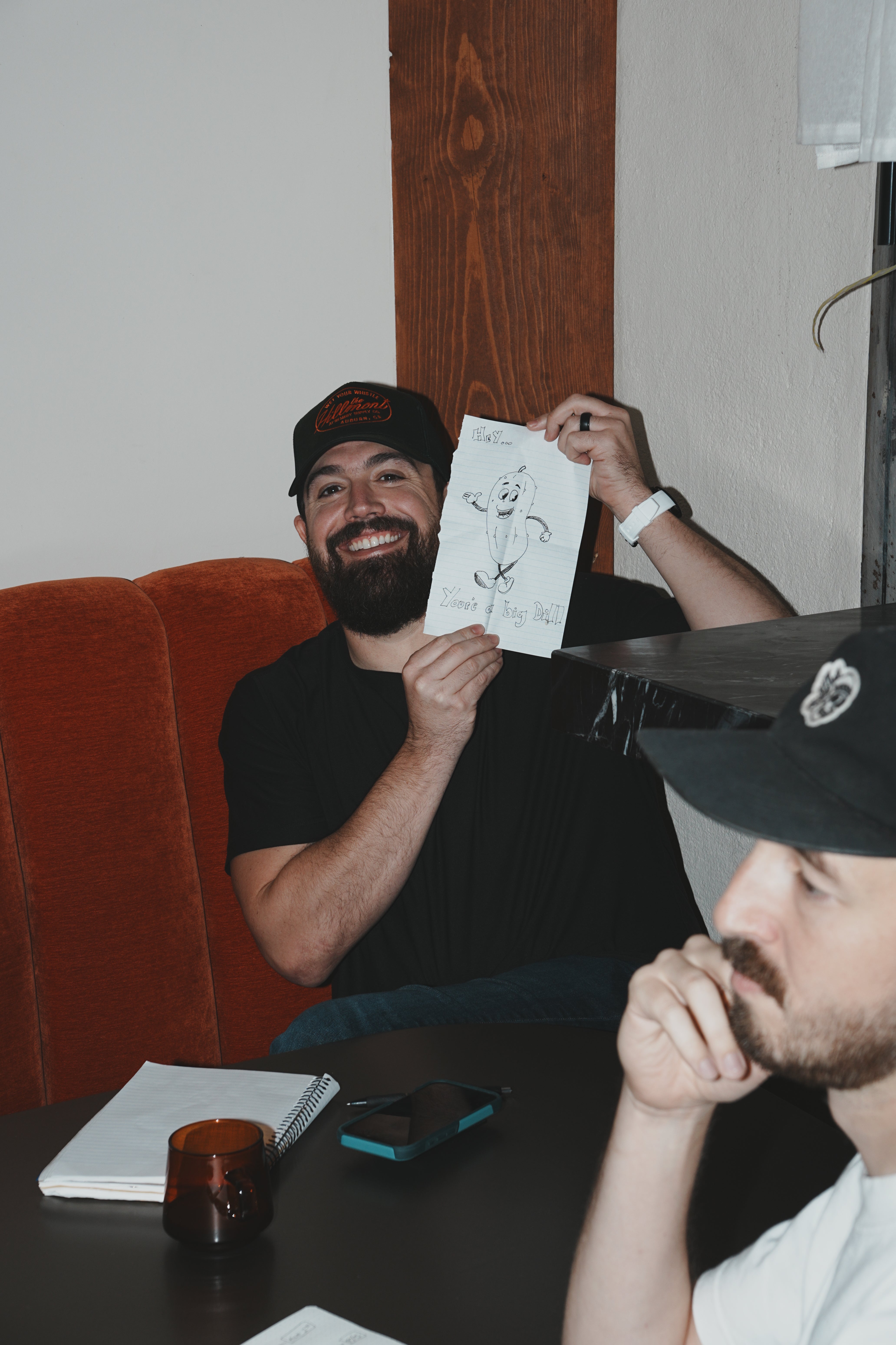Fairwell Collective team member laughing over a hand-drawn sketch