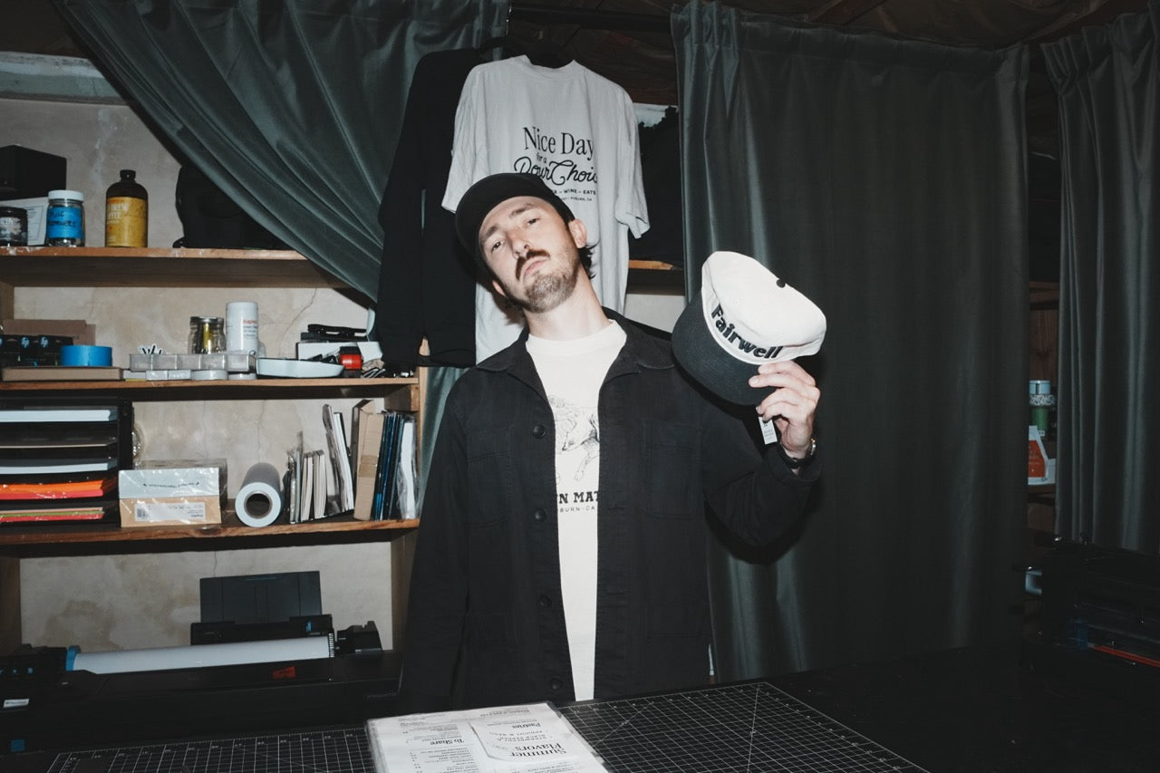 Fairwell Collective team member in a portrait wearing a Fairwell cap
