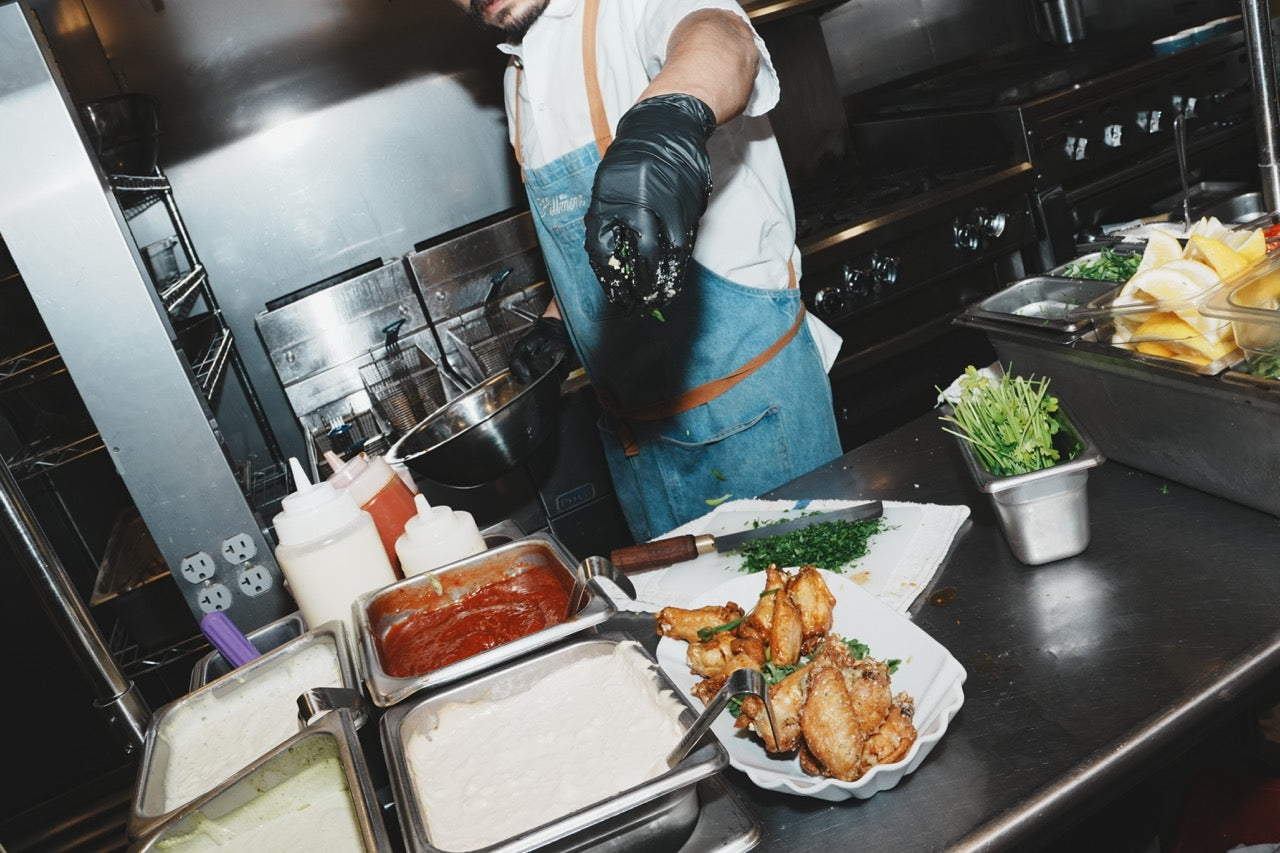 Chef seasoning a dish in a restaurant kitchen, Auburn, California