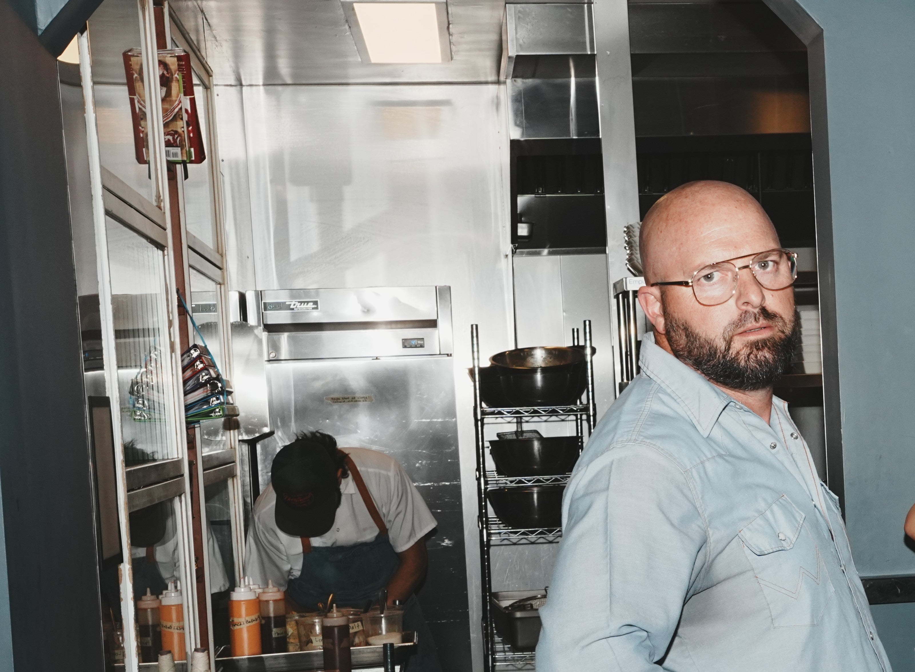 Fairwell Collective team member giving a candid look in a restaurant kitchen
