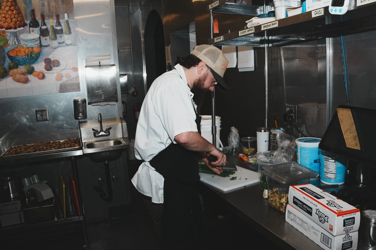 Chef reaching for supplies in a restaurant kitchen, Auburn, California